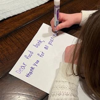 Kid writing a letter.