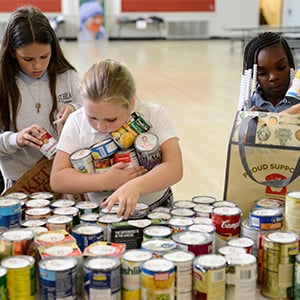 Kids sorting canned food.