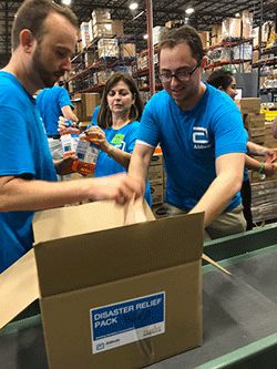 Volunteers pack disaster relief boxes