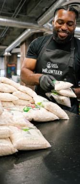 A volunteer packing food at Central CA Food Bank