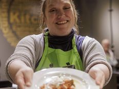 A woman holding a plate of food.