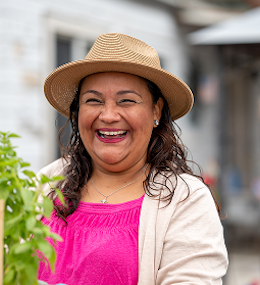 A smiling woman in her garden