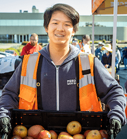 A young man volunteers at a food bank