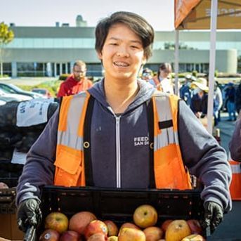 Arthur, age 14, volunteering at the produce pantry