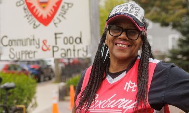 A woman standing outside and smiling.