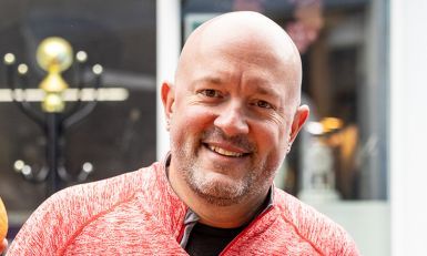 Nick holding an orange.