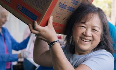 Food pantry worker carrying a box of food in Yorba Linda, California