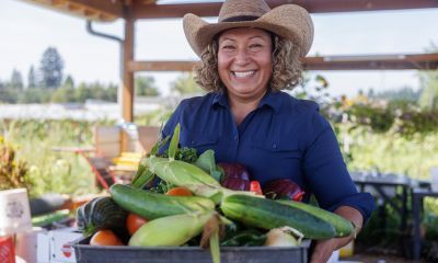 Maxi holding a box of produce.