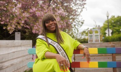 Chelsea sitting on a bench while wearing a pageant sash.