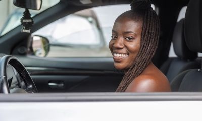 Shelby inside of a car and smiling.