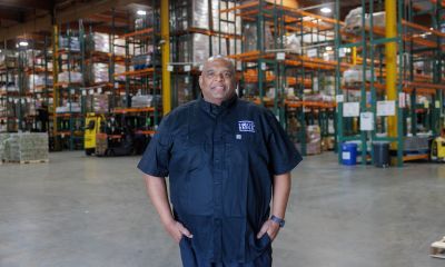 Terrance standing in a food bank warehouse.