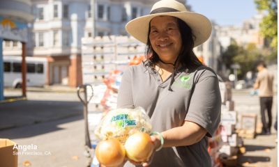 Angela holding produce.