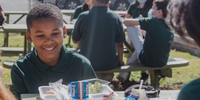 A boy eating a meal after school.