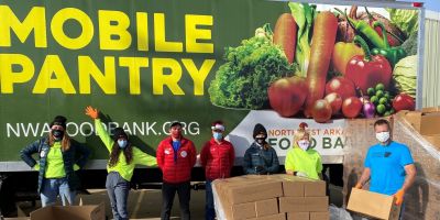 Photo of a mobile pantry truck and workers standing in front of it
