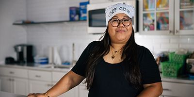 Genie wearing a chef hat and smiling.