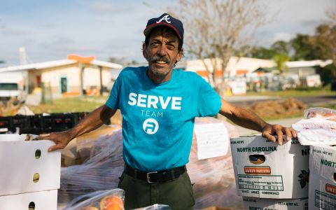 Photo of a volunteer helping out at a food distribution location