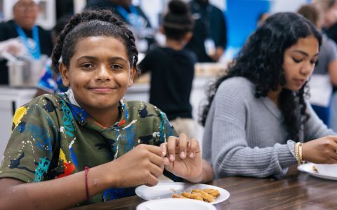A child eating a meal at school.