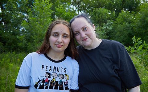 Nyx and her daughter sitting in a park.