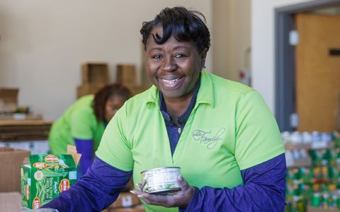 Dr. Leslie holding a can of food.