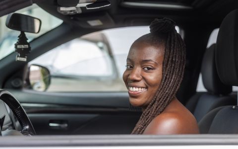 Shelby in a car and smiling.