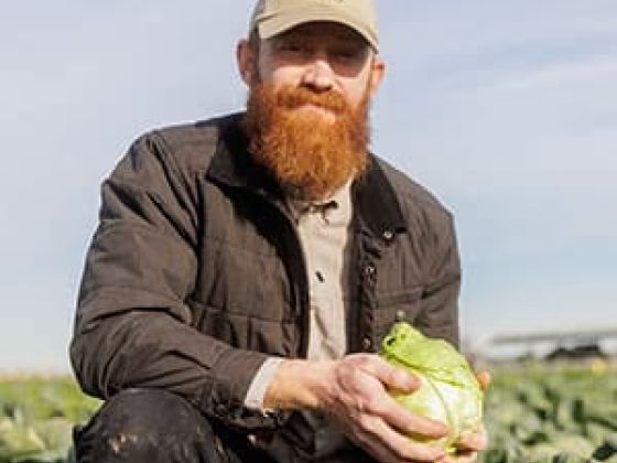 Farmer Mike holds a cabbage.