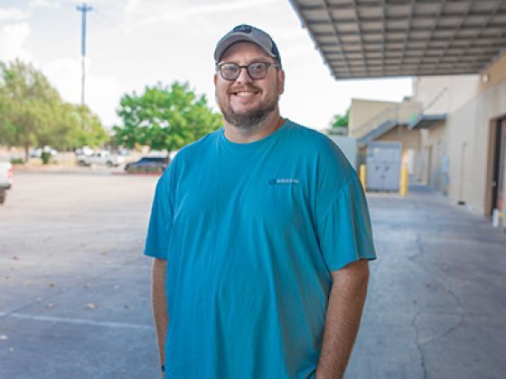 Robert standing outside of a food distribution location.