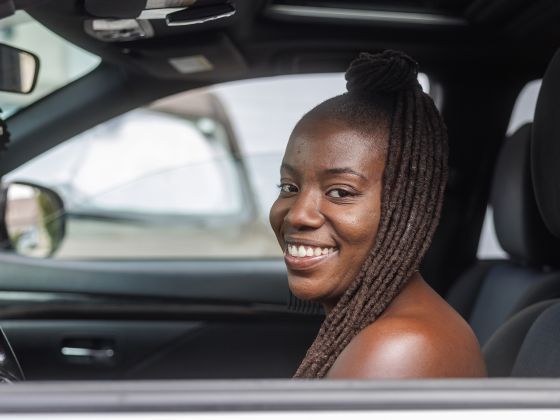 Shelby in a car and smiling.