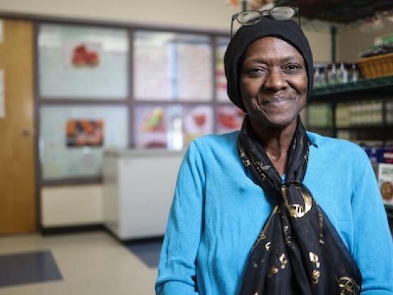 A woman in a scarf smiling