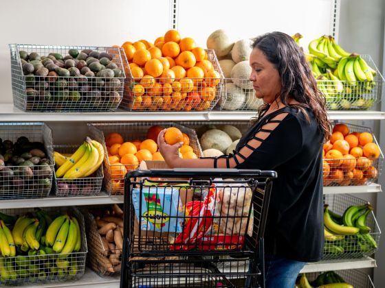 A woman shops for fresh fruit in the market