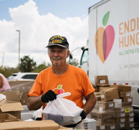 A volunteer helping out at a mobile pantry.