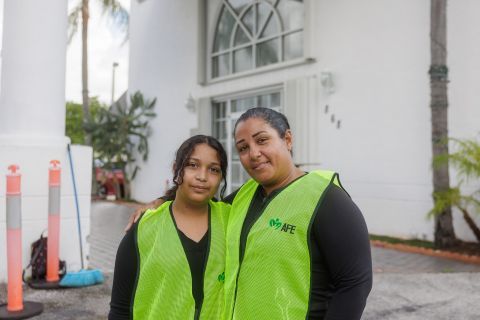 Duvrabska and her daughter standing in front of a building.