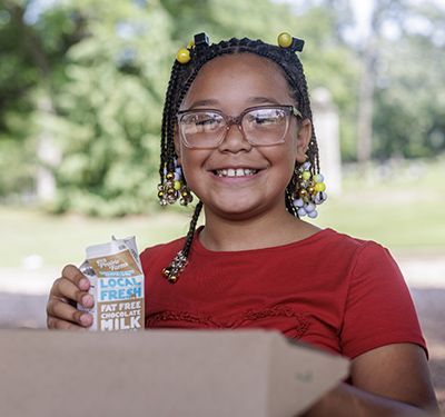 Jalissa holding a carton of milk. 