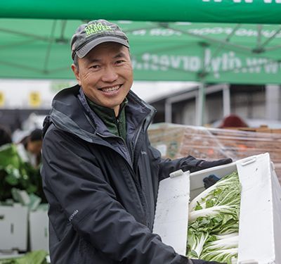 Thomas holding a box of lettuce.