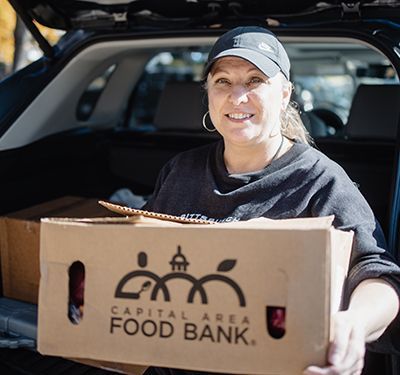 Amy holding a box of food.