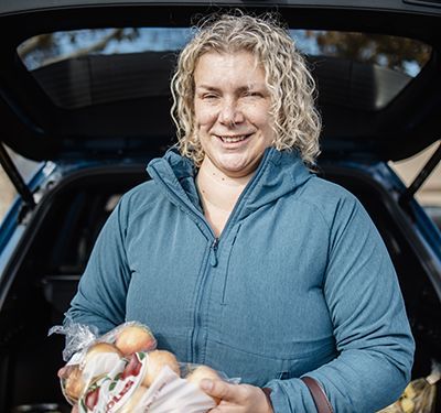 Kathryn holding a bag of apples.