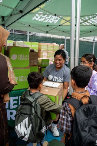 HelloFresh volunteers distribute food boxes