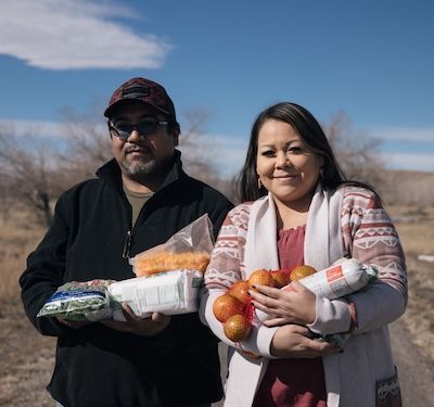 The Hill family holding food.