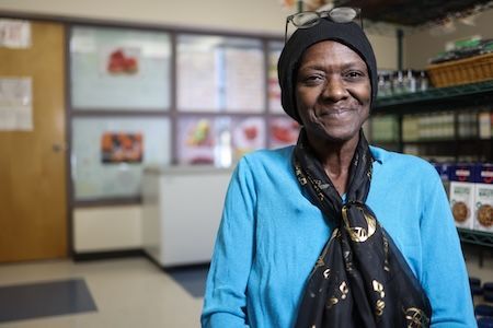 A woman in a scarf smiling