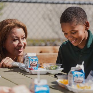 Irene, the community school coordinator, talks to Elijah