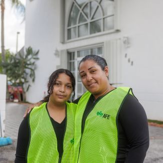 Duvrabska and her daughter standing in front of a building.