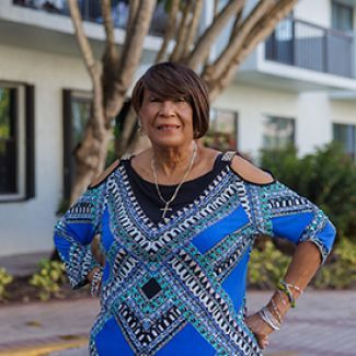 Mariela standing in front of an apartment building.