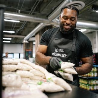 A volunteer packing food at Central CA Food Bank