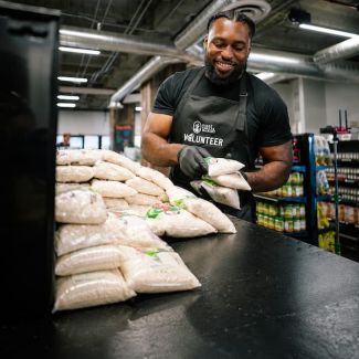 A volunteer packing food at Central CA Food Bank