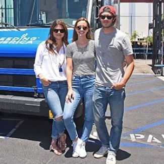 Tiffani Thiessen, Leighton Meester and Adam Brody pose in front of Feeding America’s ice cream truck. 