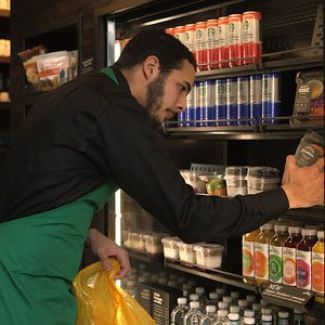 A Starbucks employee collecting food to be donated.