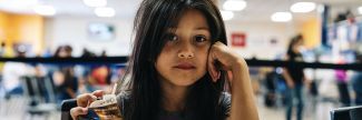Iliana, 7, eats lunch at a summer meals site in Phoenix, Arizona.
