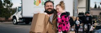 Martin and Rylee picking up food from mobile food bank
