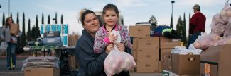 Mom and daughter at food bank after disaster