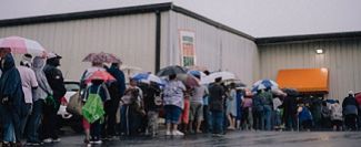 Photo of neighbors waiting for food distribution in line