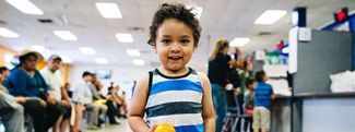 Juan Alfredo, 2, eats an orange at a summer meals program in Phoenix, Arizona.